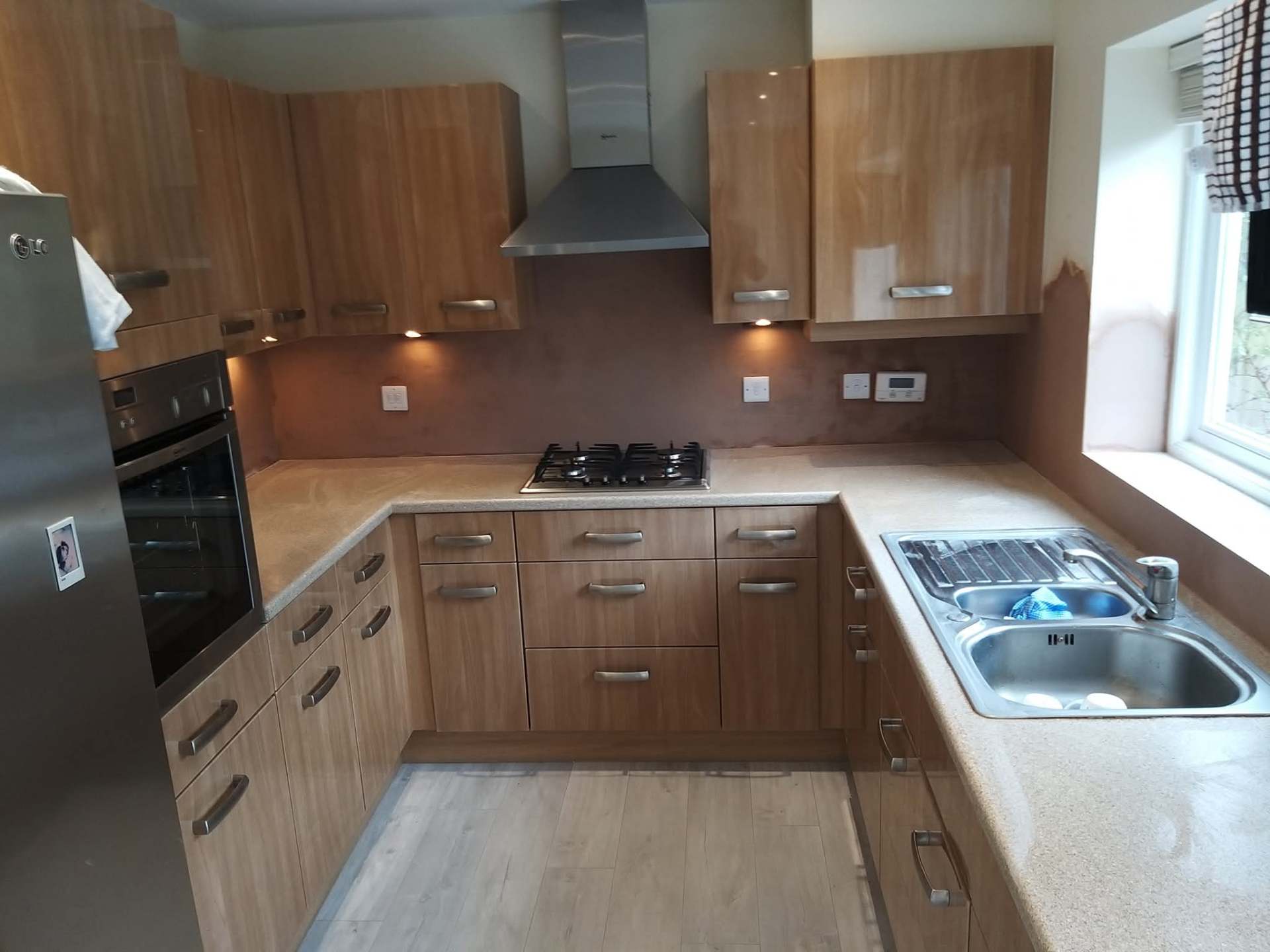 Kitchen splashback area freshly plastered around fitted units