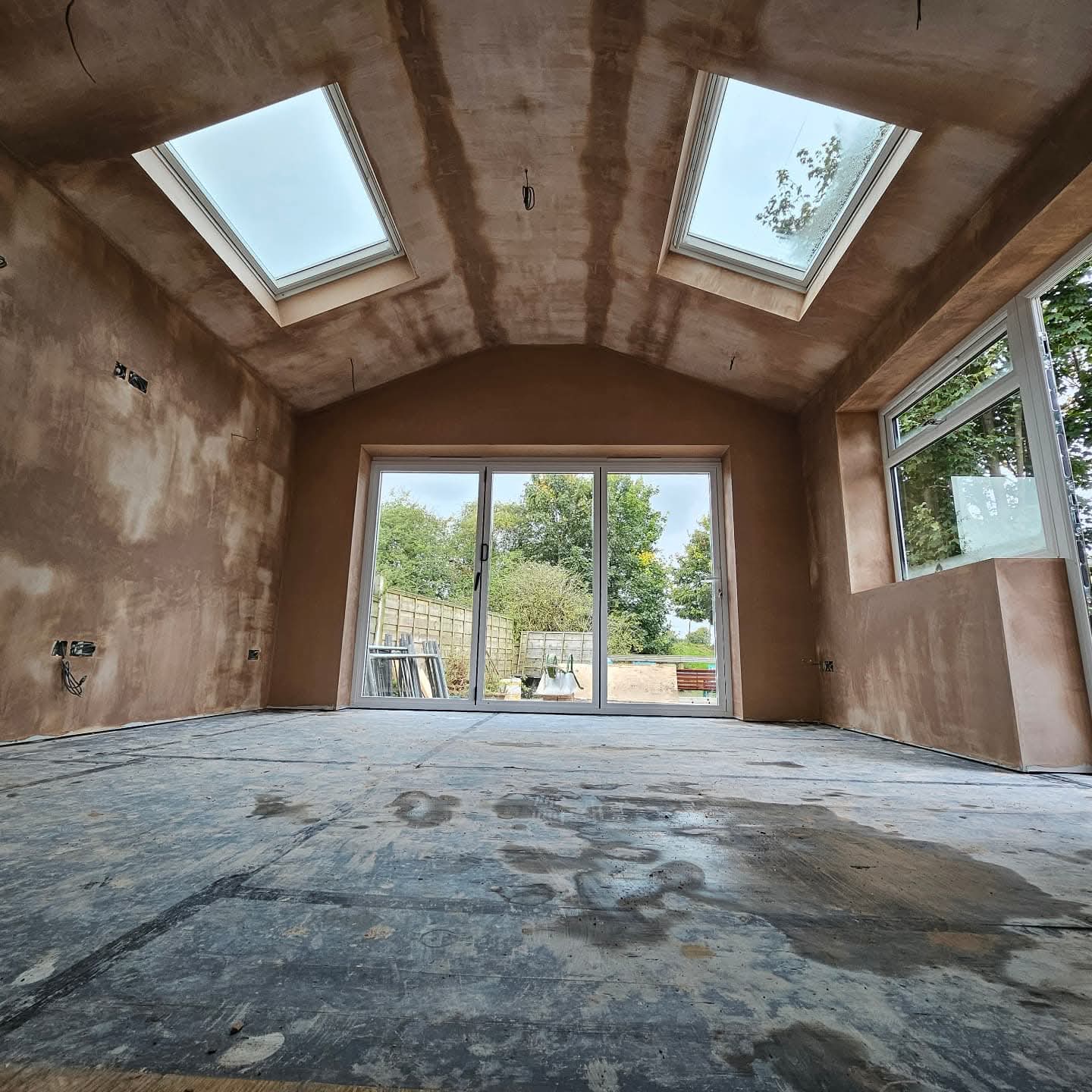 Vaulted ceiling and walls freshly skimmed with pink plaster